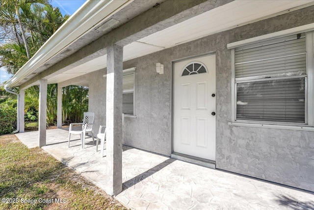 entrance to property with a patio