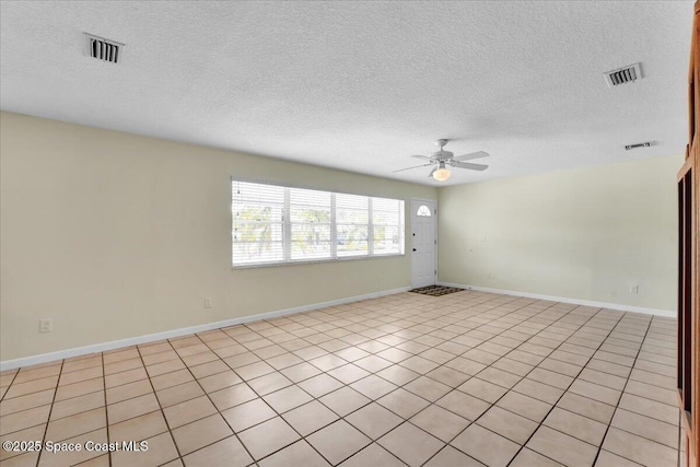 spare room with a textured ceiling and ceiling fan