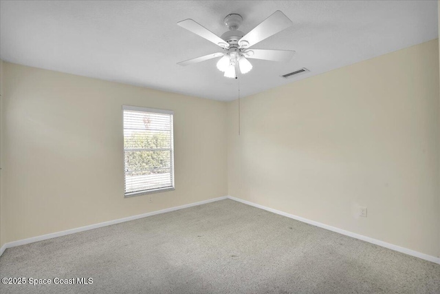 carpeted spare room featuring ceiling fan