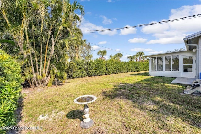 view of yard featuring a sunroom