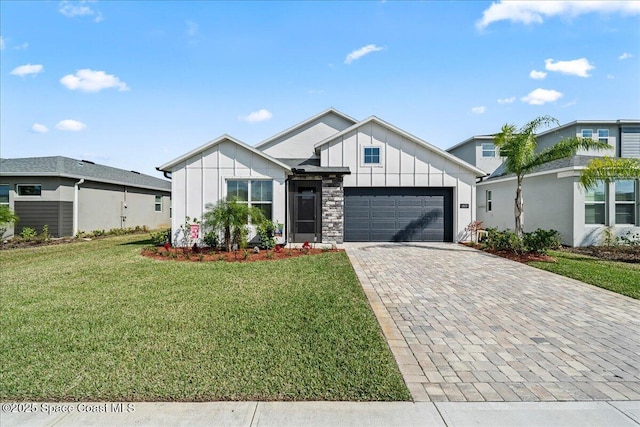 view of front of home featuring a garage and a front lawn