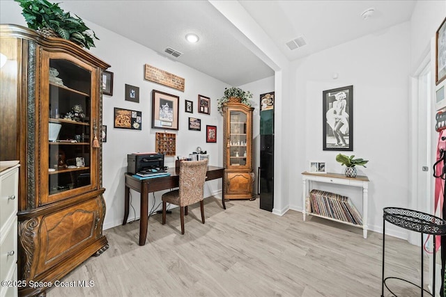 office with light hardwood / wood-style flooring