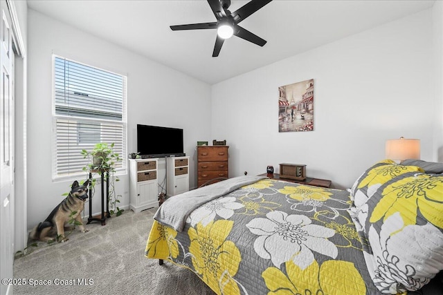 bedroom with ceiling fan and light carpet