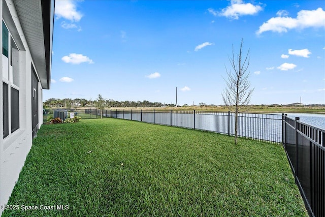 view of yard featuring a water view and central AC unit