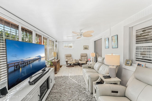 living room featuring hardwood / wood-style flooring and ceiling fan