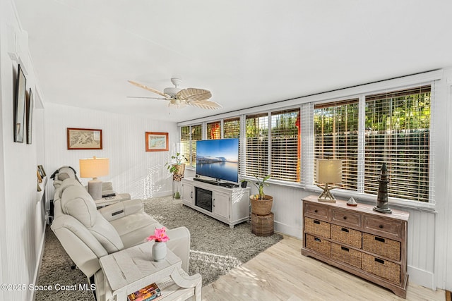 living room with ceiling fan and light wood-type flooring