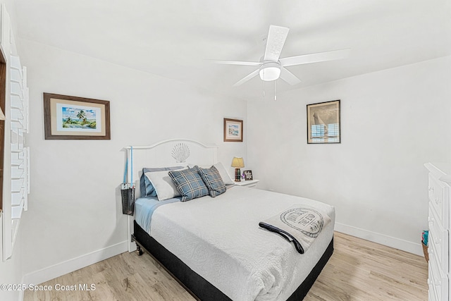 bedroom with ceiling fan and light hardwood / wood-style flooring