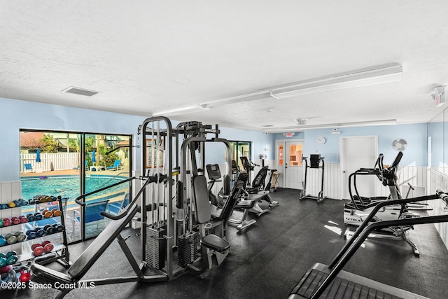 exercise room with a textured ceiling