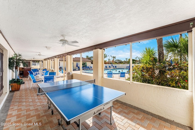 view of patio / terrace with a community pool and ceiling fan