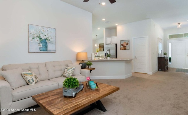 living room featuring ceiling fan and light carpet