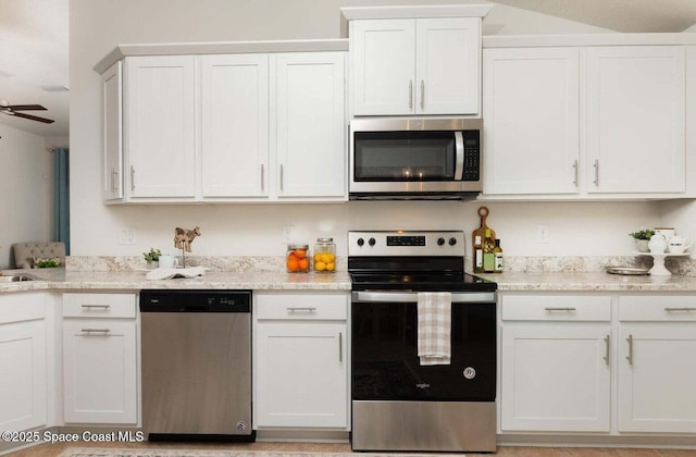 574 Fernwood Ave NW None, Unit None, Palm Bay, FL 32907 - kitchen with stainless steel appliances, white cabinetry, light stone counters, and a ceiling fan