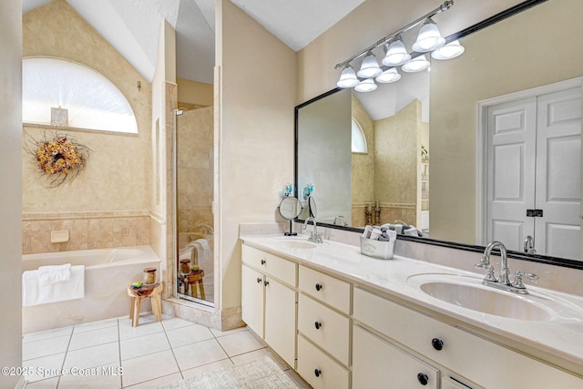 bathroom with tile patterned flooring, a stall shower, and a sink