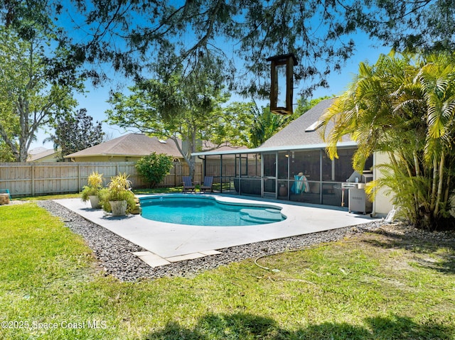 view of pool with a patio area, a yard, a fenced backyard, and a sunroom