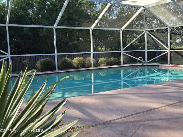 view of pool featuring a patio and glass enclosure