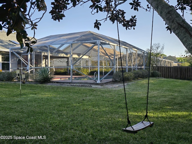 view of property's community with a fenced in pool, glass enclosure, and a lawn