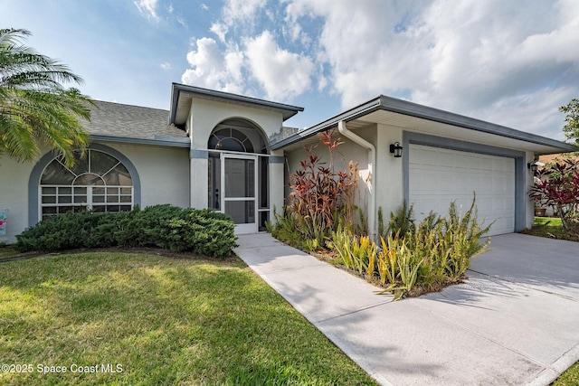 single story home featuring a garage and a front lawn