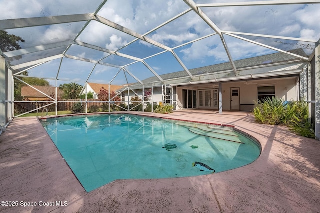 view of pool featuring a lanai, ceiling fan, and a patio area