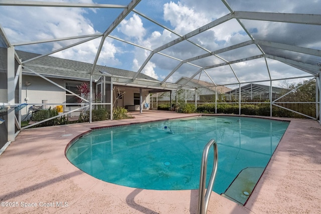 view of swimming pool featuring a lanai and a patio area