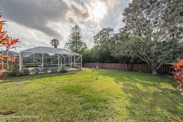 view of yard with glass enclosure