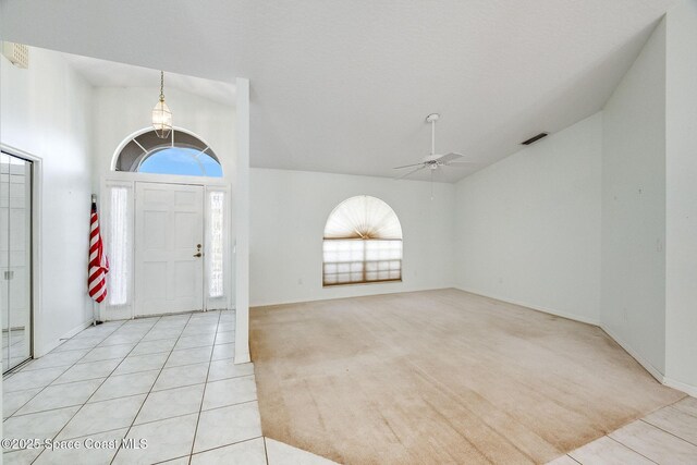 tiled entrance foyer featuring high vaulted ceiling and ceiling fan