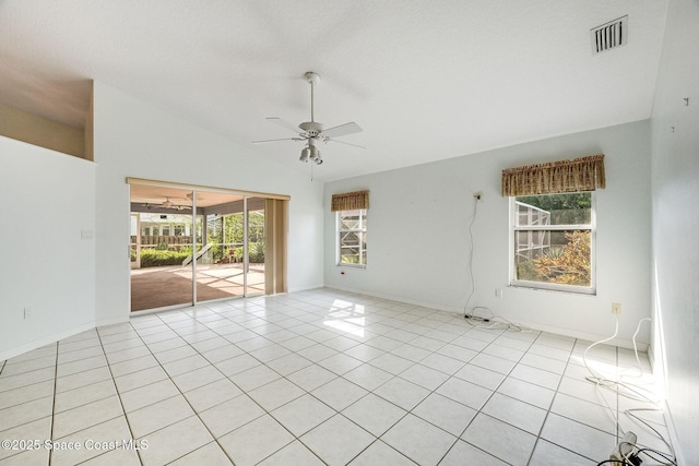 tiled empty room featuring lofted ceiling and ceiling fan