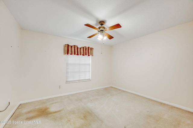 unfurnished room with ceiling fan and light carpet