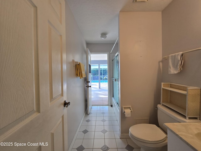 bathroom with vanity, a textured ceiling, tile patterned floors, toilet, and walk in shower