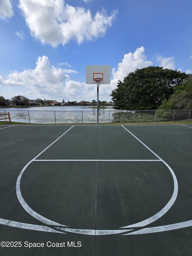 view of basketball court with a water view