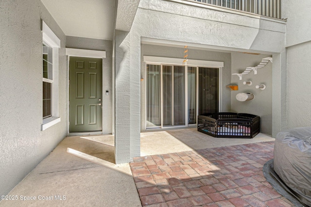 entrance to property featuring a patio area