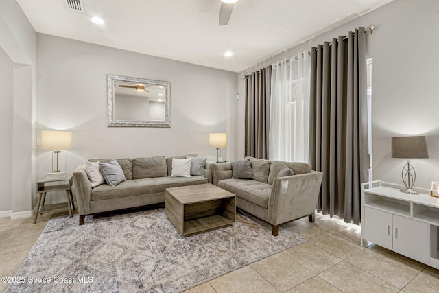 tiled living room with ceiling fan