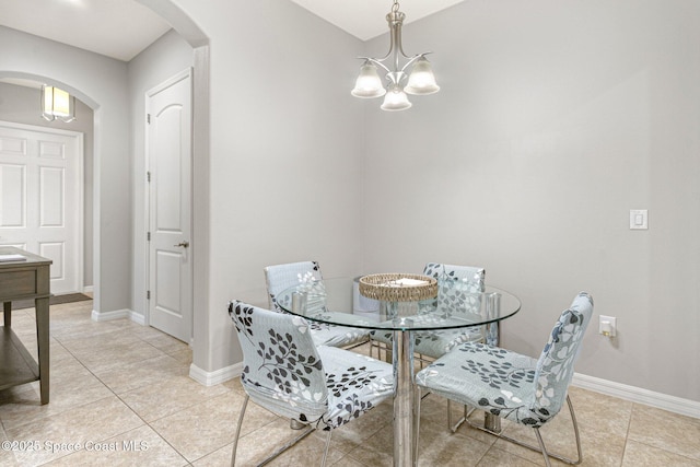 tiled dining area with a notable chandelier