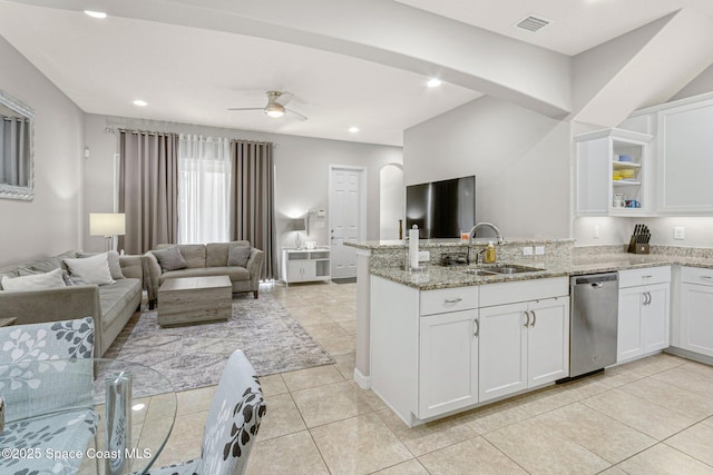 kitchen featuring white cabinetry, dishwasher, sink, kitchen peninsula, and light stone countertops