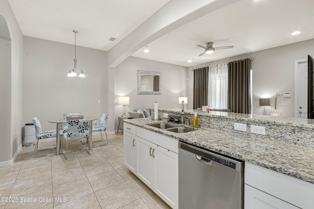 kitchen featuring ceiling fan with notable chandelier, white cabinetry, sink, stainless steel dishwasher, and light stone countertops