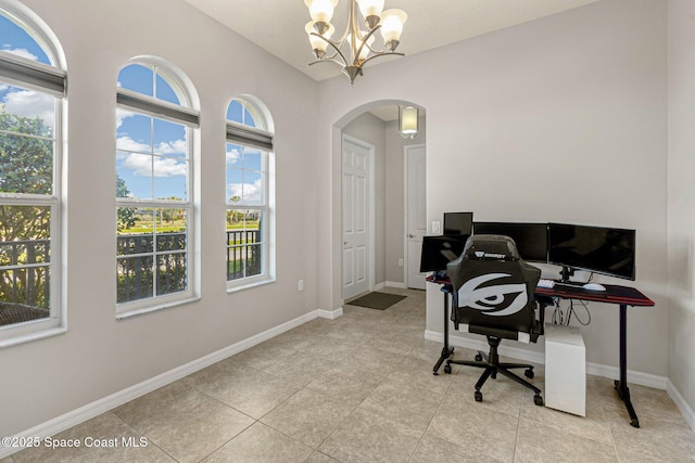 tiled home office with a chandelier