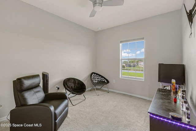 living area featuring carpet flooring and ceiling fan