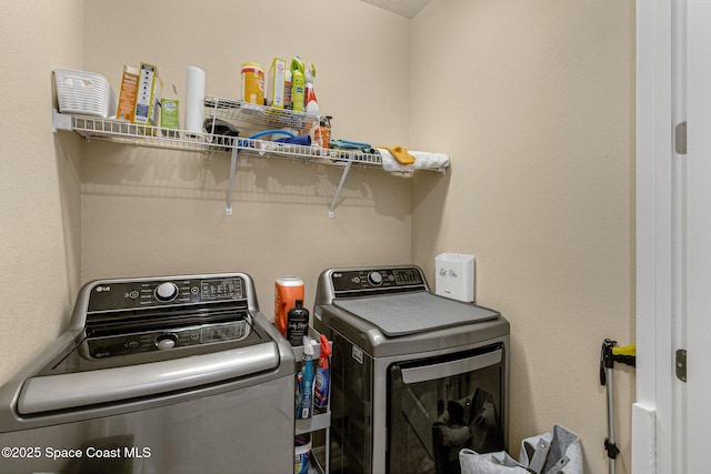 washroom with washing machine and dryer