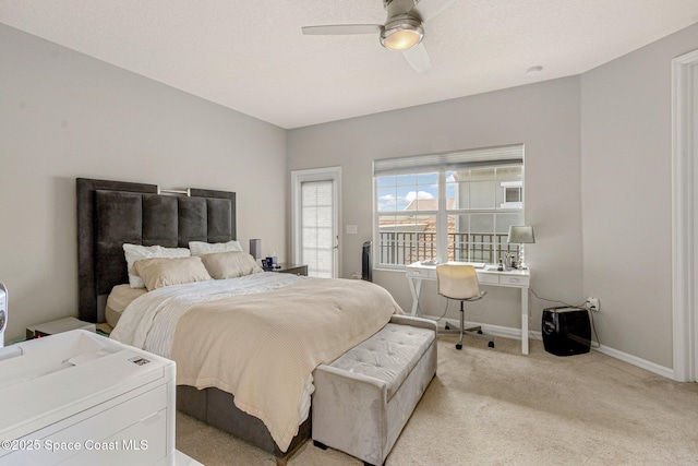 carpeted bedroom featuring a textured ceiling and ceiling fan