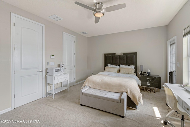 bedroom with ceiling fan and light carpet