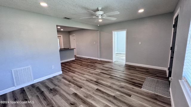 interior space featuring ceiling fan, hardwood / wood-style floors, and a textured ceiling