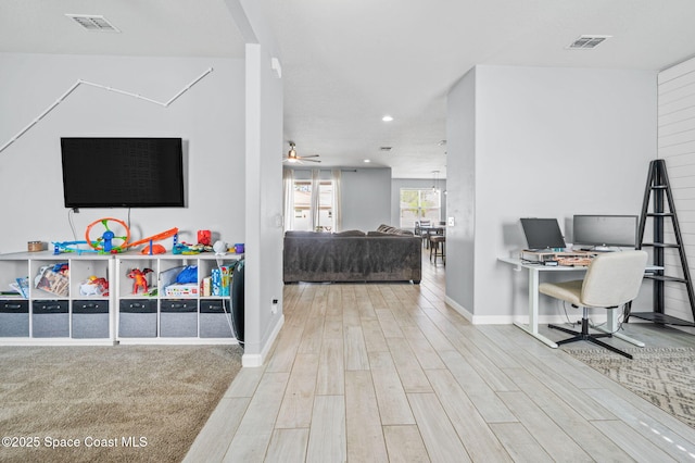 interior space with hardwood / wood-style floors and ceiling fan