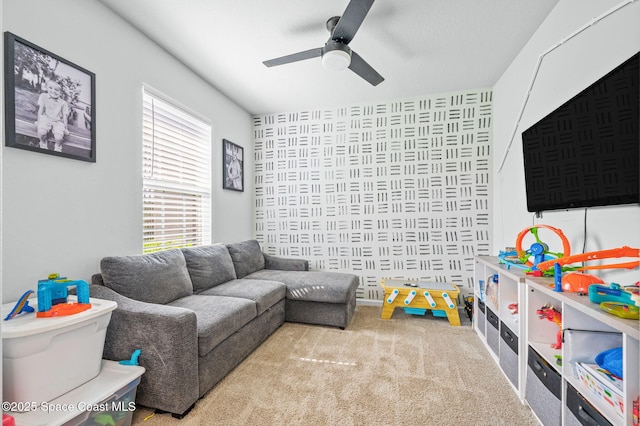 game room featuring plenty of natural light, ceiling fan, and carpet