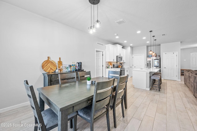 dining room with light hardwood / wood-style flooring