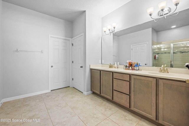 bathroom featuring an inviting chandelier, tile patterned floors, vanity, and walk in shower