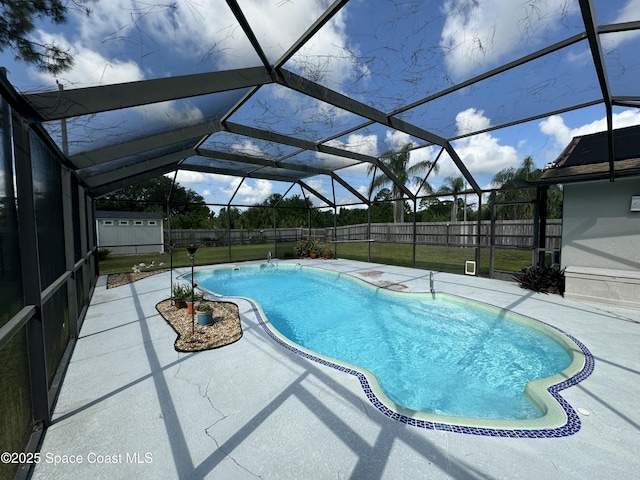 view of pool with a yard, a lanai, and a patio area