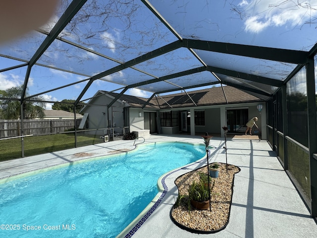 view of swimming pool featuring a lanai and a patio