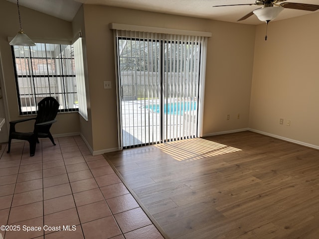 unfurnished room with wood-type flooring, vaulted ceiling, and ceiling fan