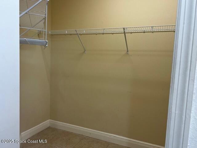 spacious closet featuring tile patterned flooring