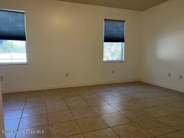 tiled spare room with plenty of natural light