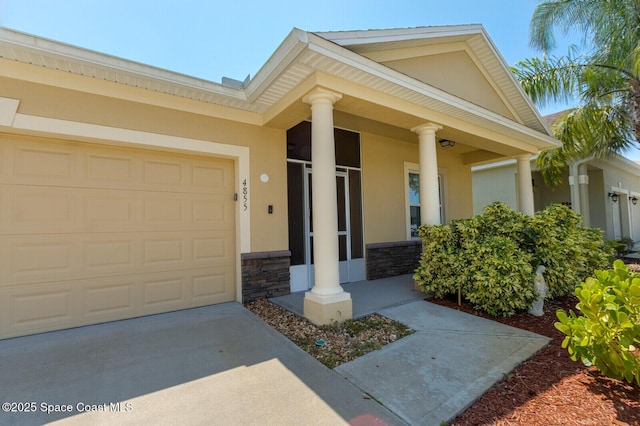 view of exterior entry with a garage