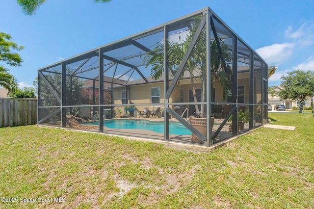 rear view of house featuring a yard, a lanai, a fenced in pool, and a patio area